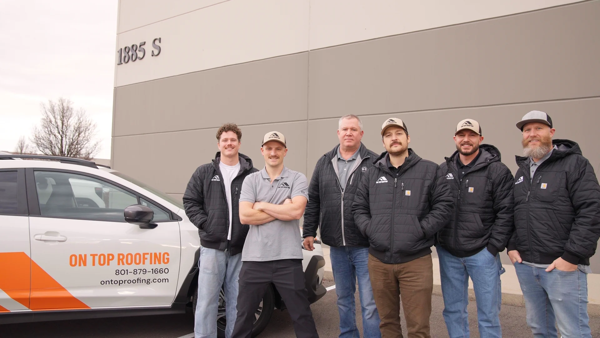 two-story home with aging shingles shown during roof inspection