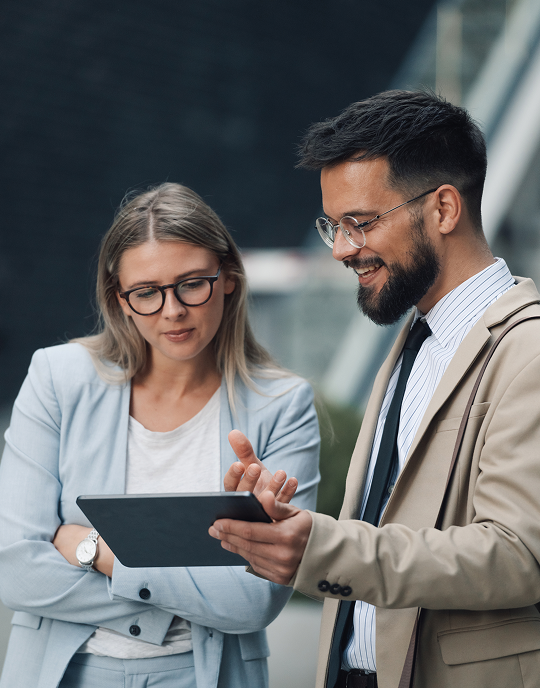 A consultant and client reviewing an AI strategy roadmap on a tablet