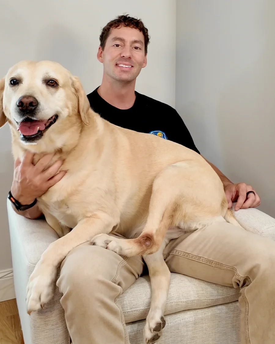 Dylan Solberg with Bella, his yellow Lab and the original Cyber Dog