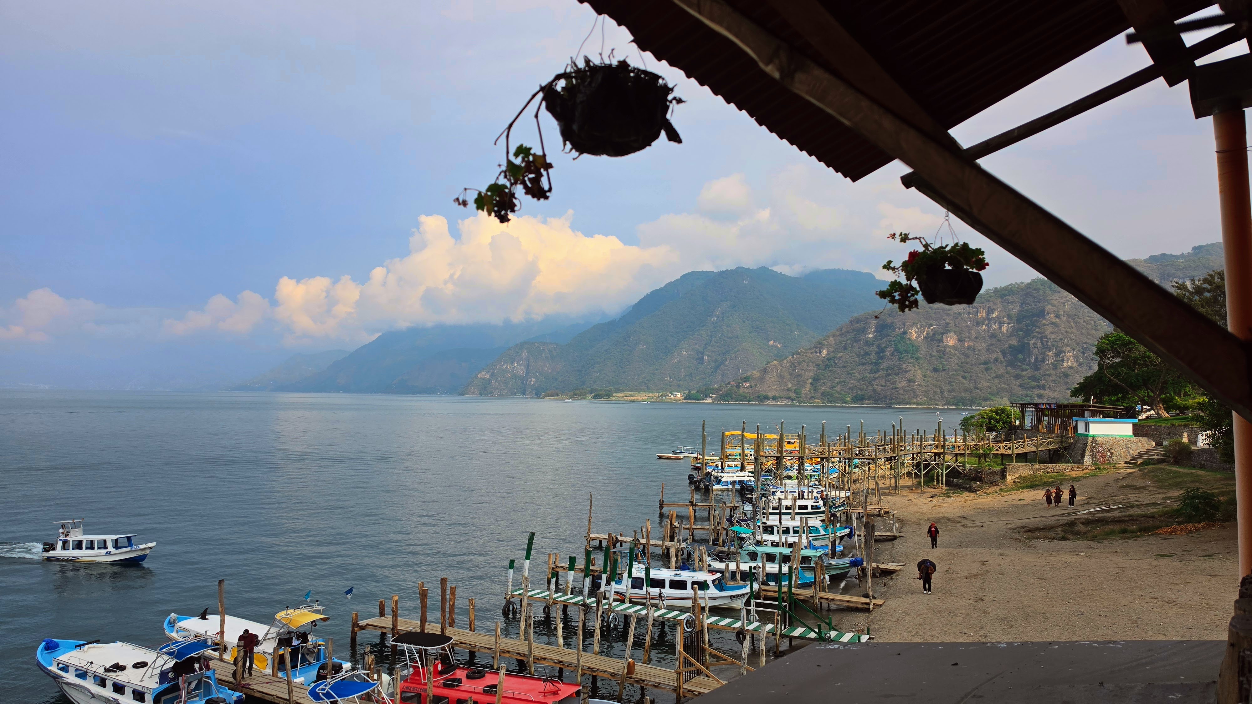 Dramatic view of Lake Atitlán surrounded by volcanoes and blue water