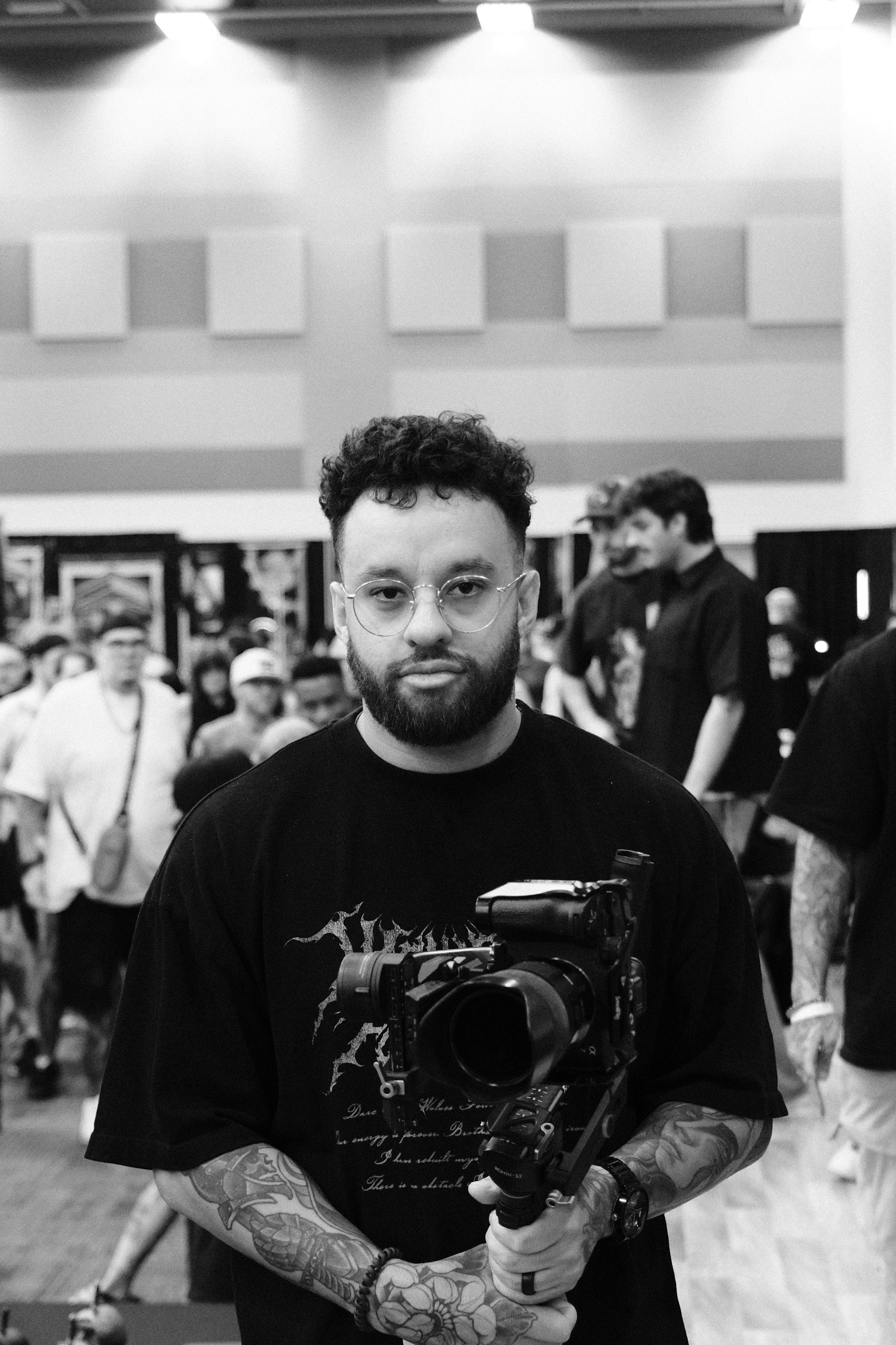 Noah Dabreo, founder of NDMedia, holding a professional camera