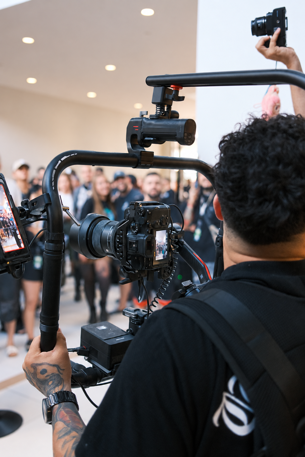 Camera operator filming an event with a stabilizer rig