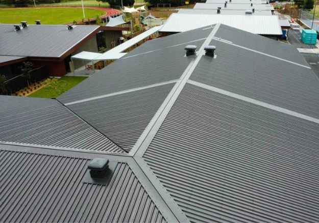 Long run commercial roofing installation on an Auckland building
