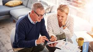 Two people sitting together reviewing plan paperwork.