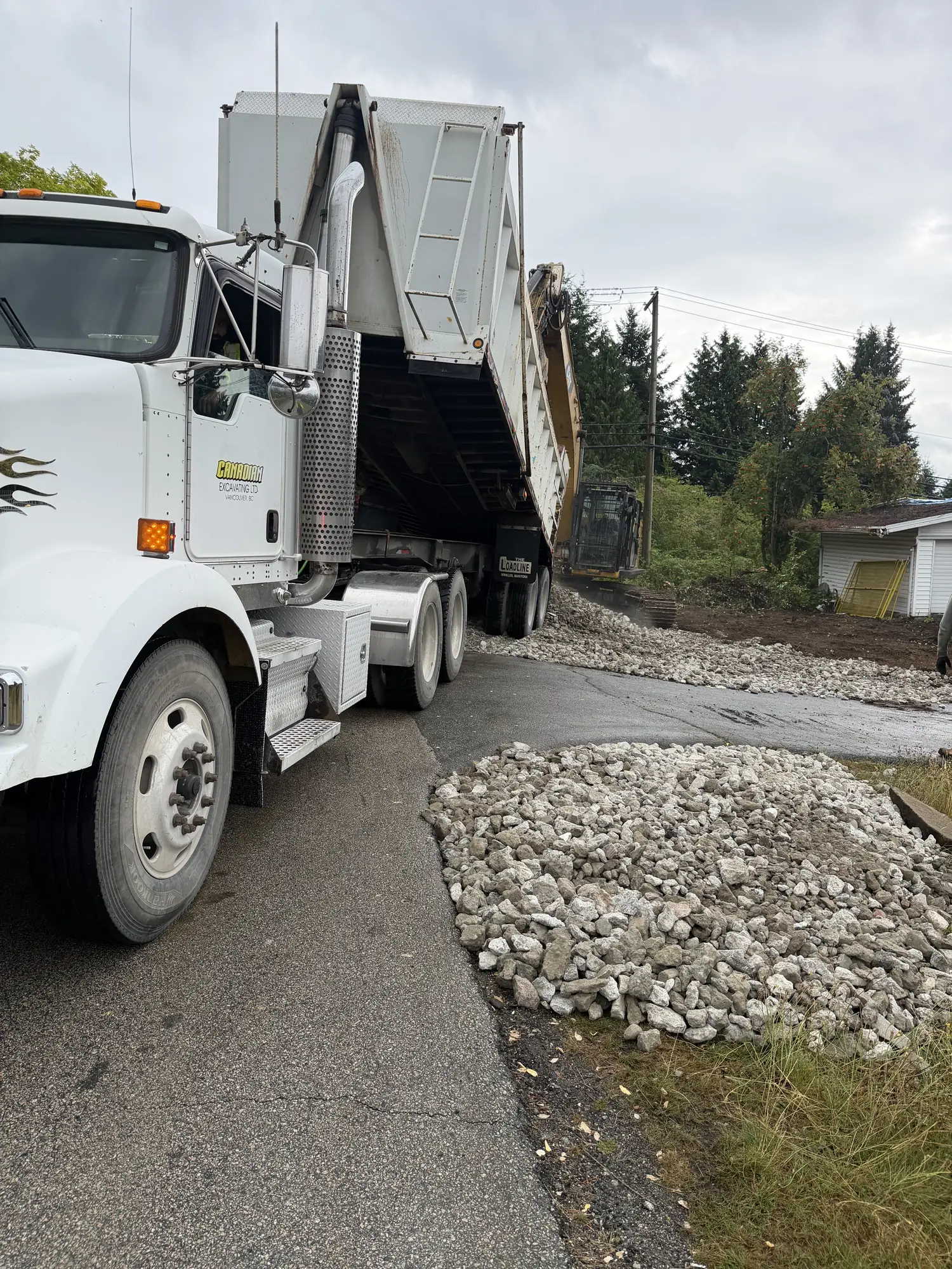 Dump truck delivering clean fill on a Delta BC site