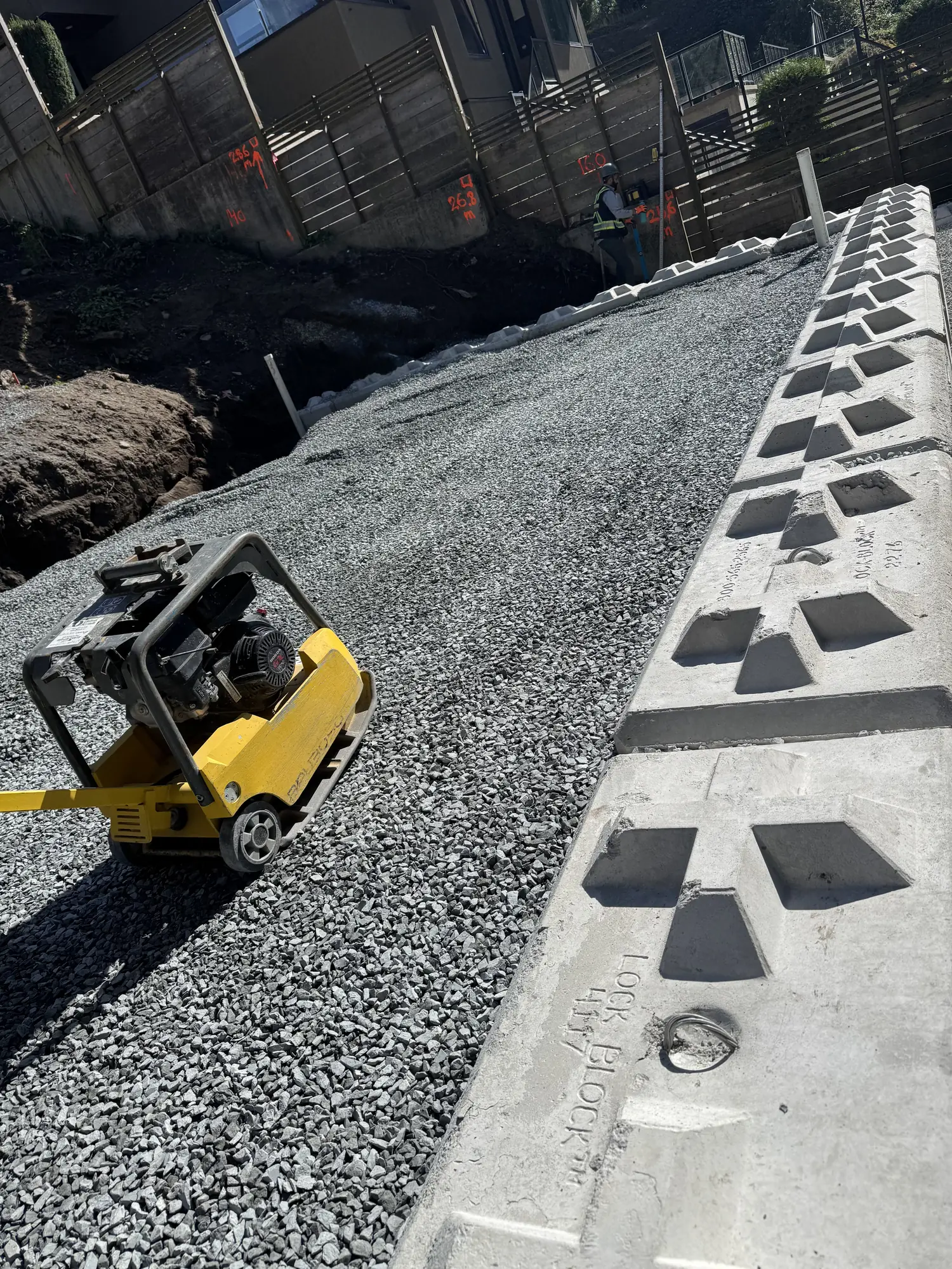 Shoring and retaining wall installation on a sloped lot in Vancouver