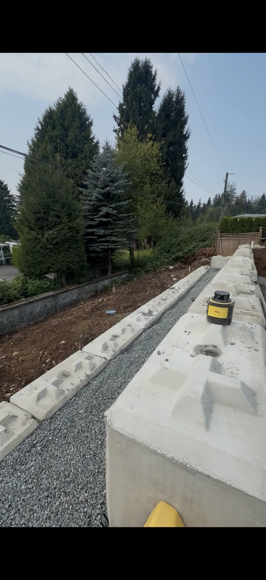 Completed retaining wall holding back soil in North Vancouver BC