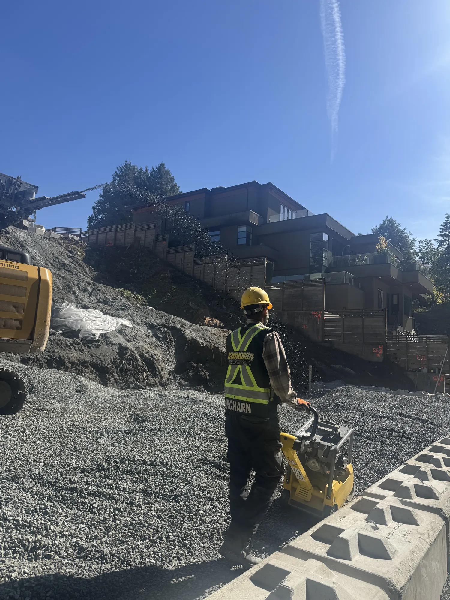 Engineered retaining wall holding back a sloped cut in North Vancouver BC