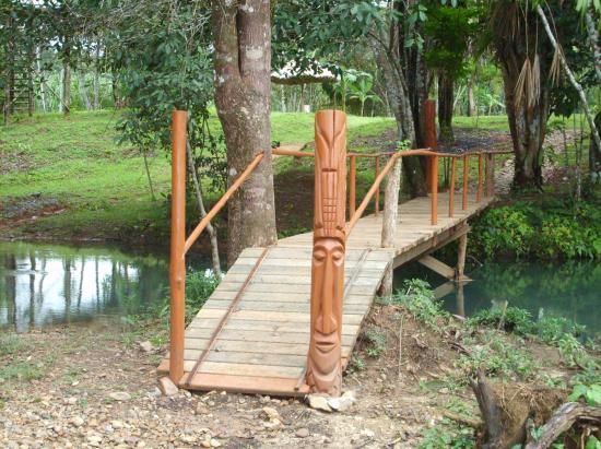 Carved wooden footbridge over the creek