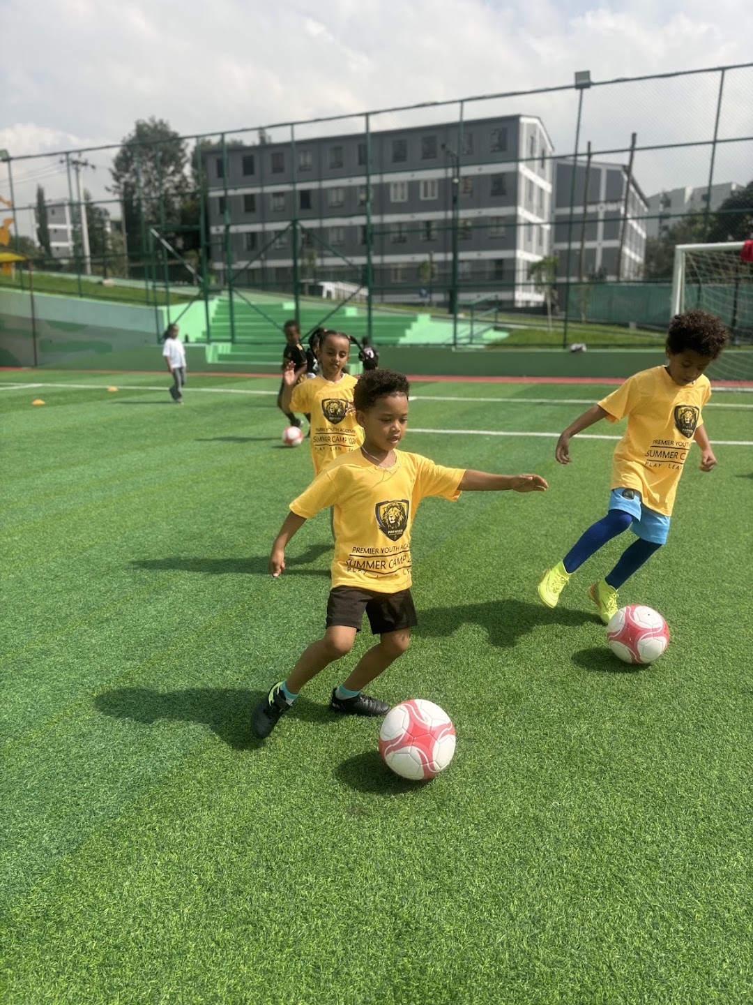 Young PYA players practising ball control together on the pitch