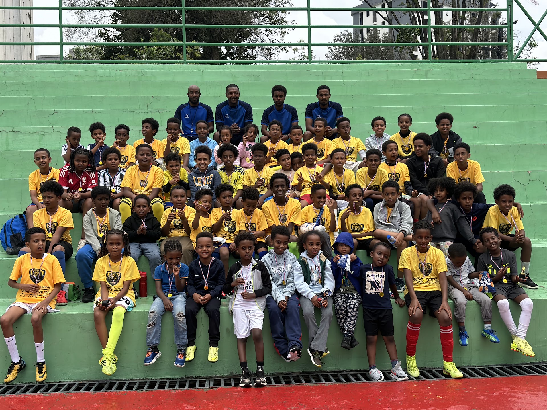 PYA players of different ages and their coaches together at Addis Sport Park