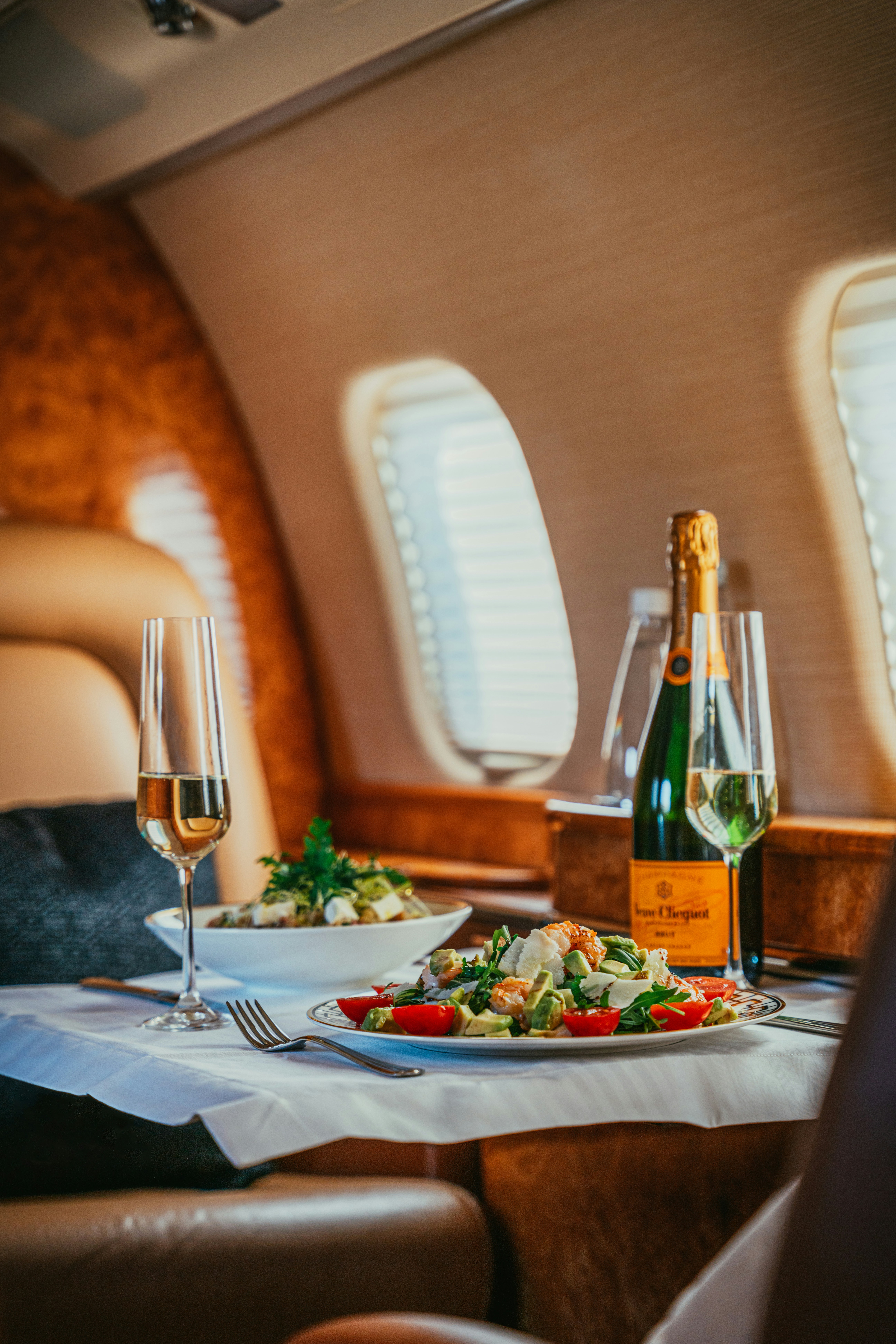 Luxury private jet dining with gourmet cuisine and champagne