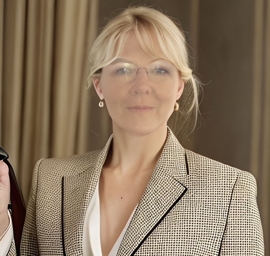 Dr. Trudy Larimore Walker, chiropractor, smiling in professional white coat at Catalina Mountain Chiropractic.