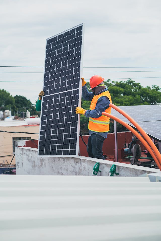 Instalador colocando panel solar en tejado
