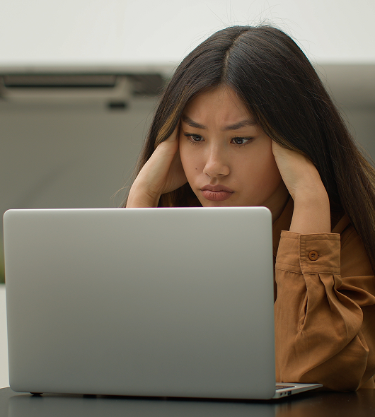 Woman having a headache at the computer