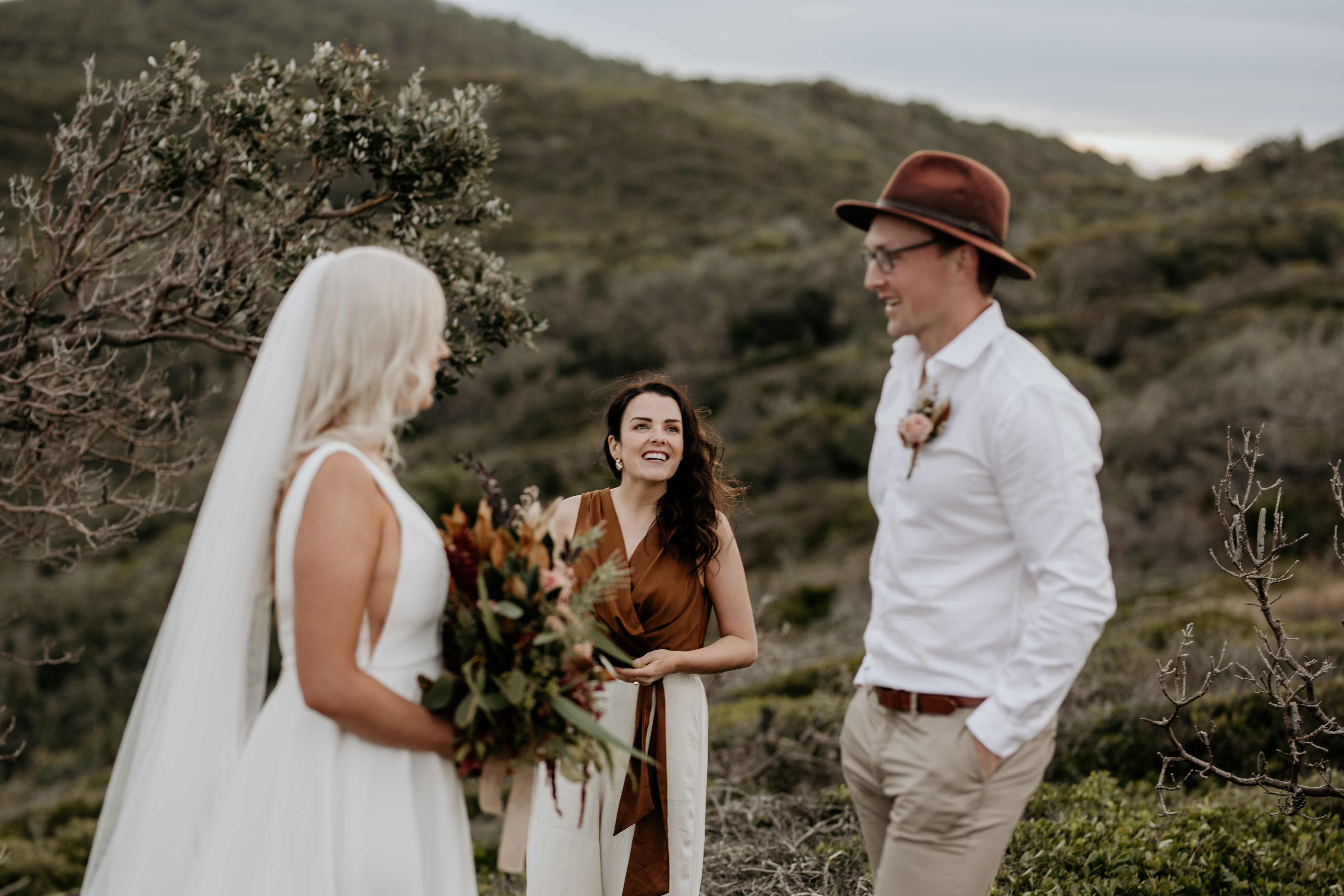 A wedding ceremony under a canopy of trees