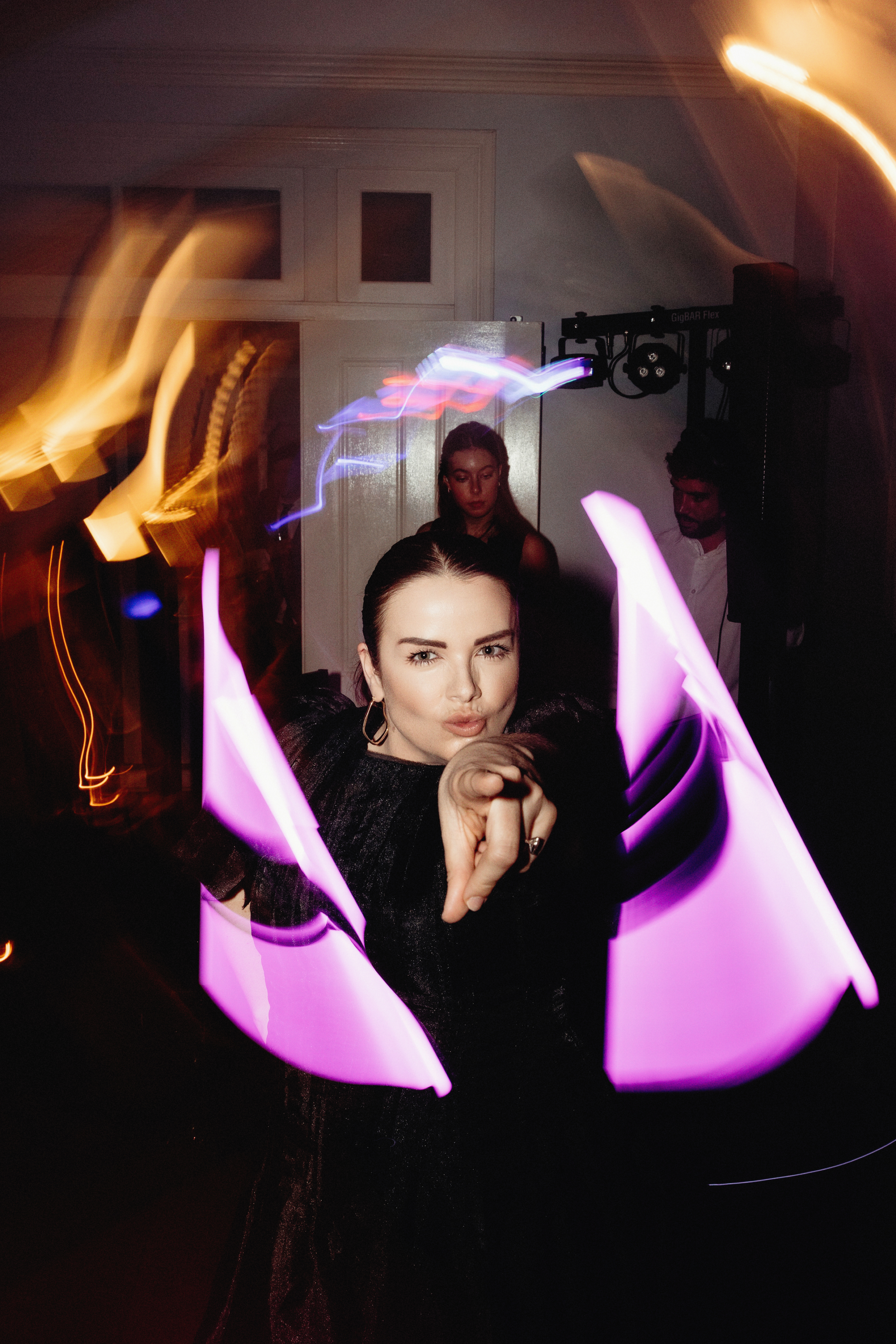 Danielle at a reception under coloured light