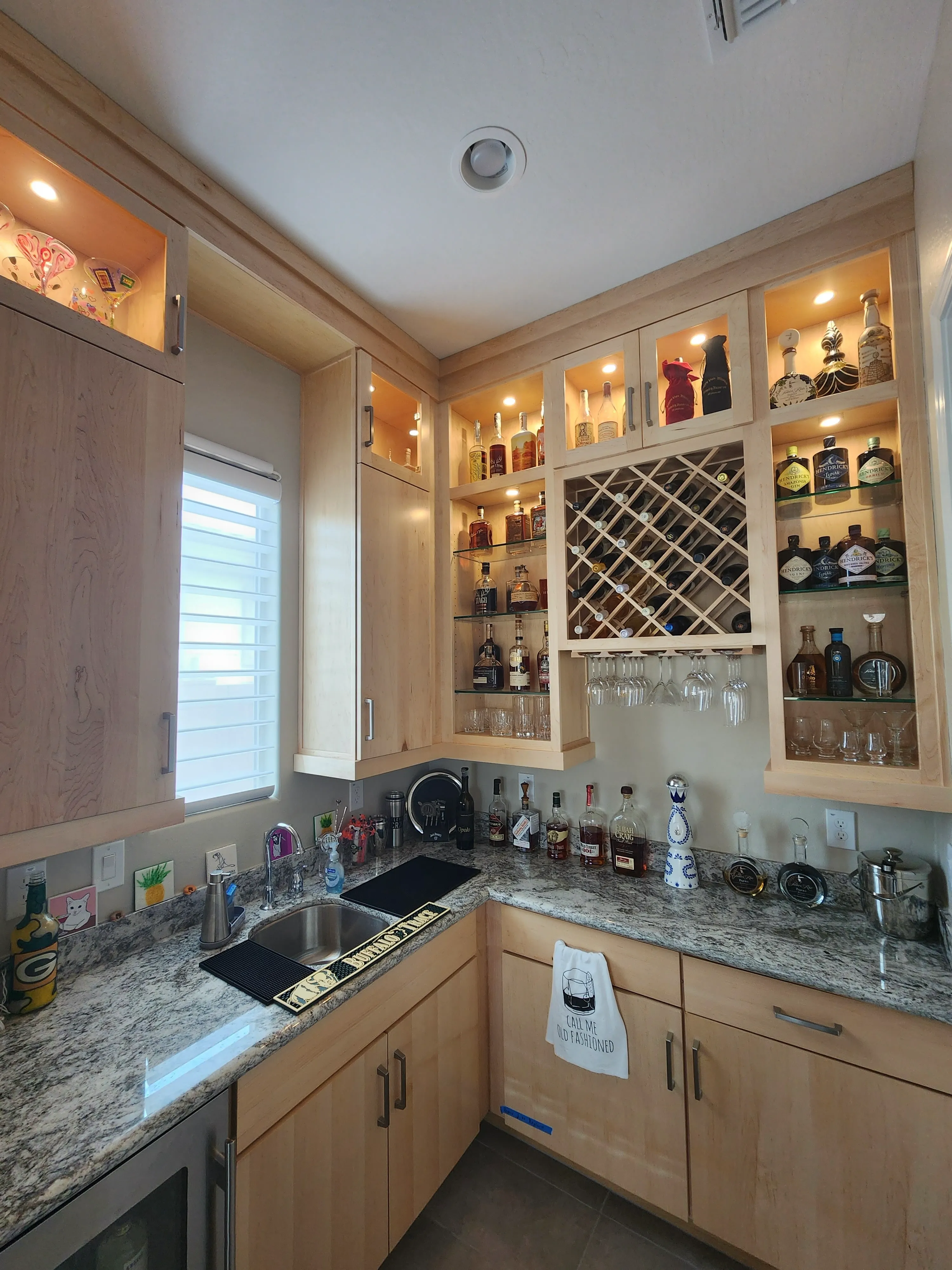 Custom cabinet and display lighting in a residential bar area