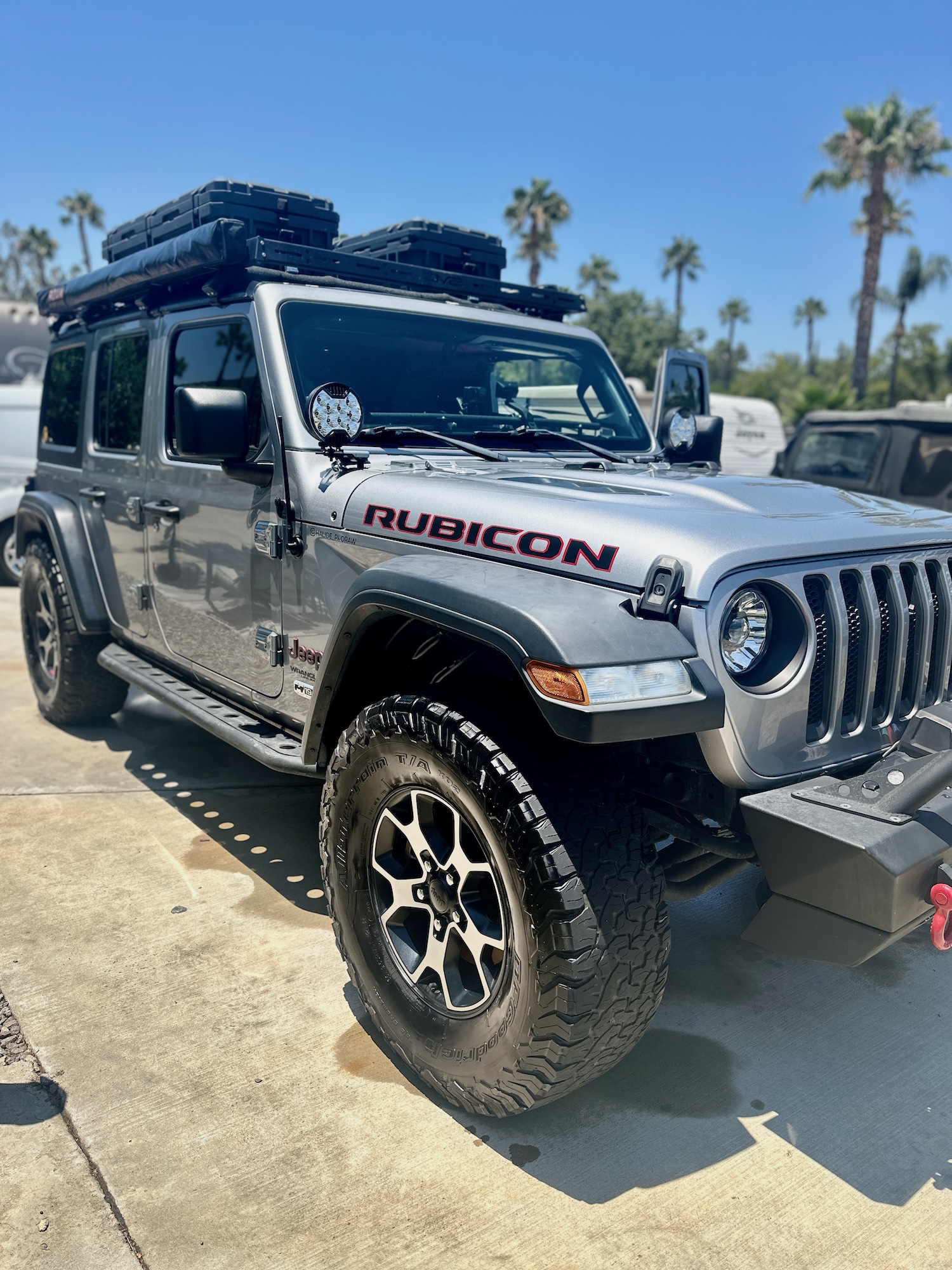 lver Jeep Rubicon SUV after exterior detailing, showcasing tire dressing, clean paintwork, and off-road accessories under a sunny San Diego sky