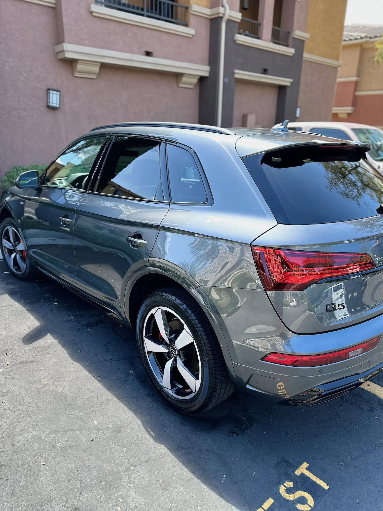 Shiny grey Audi Q5 SUV parked outdoors after premium exterior auto detailing.