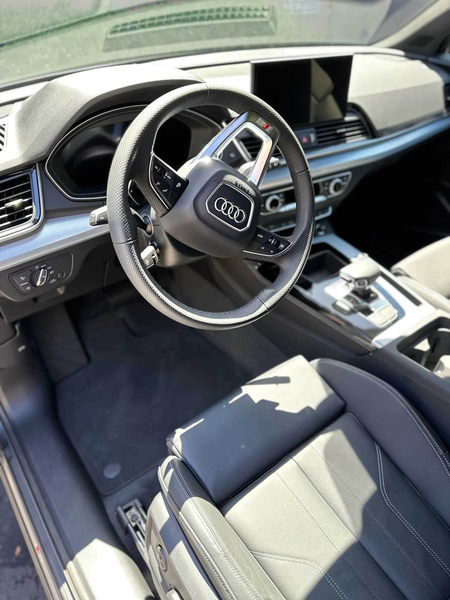 Clean and modern Audi S-line interior with leather seats and digital dashboard after premium detailing.