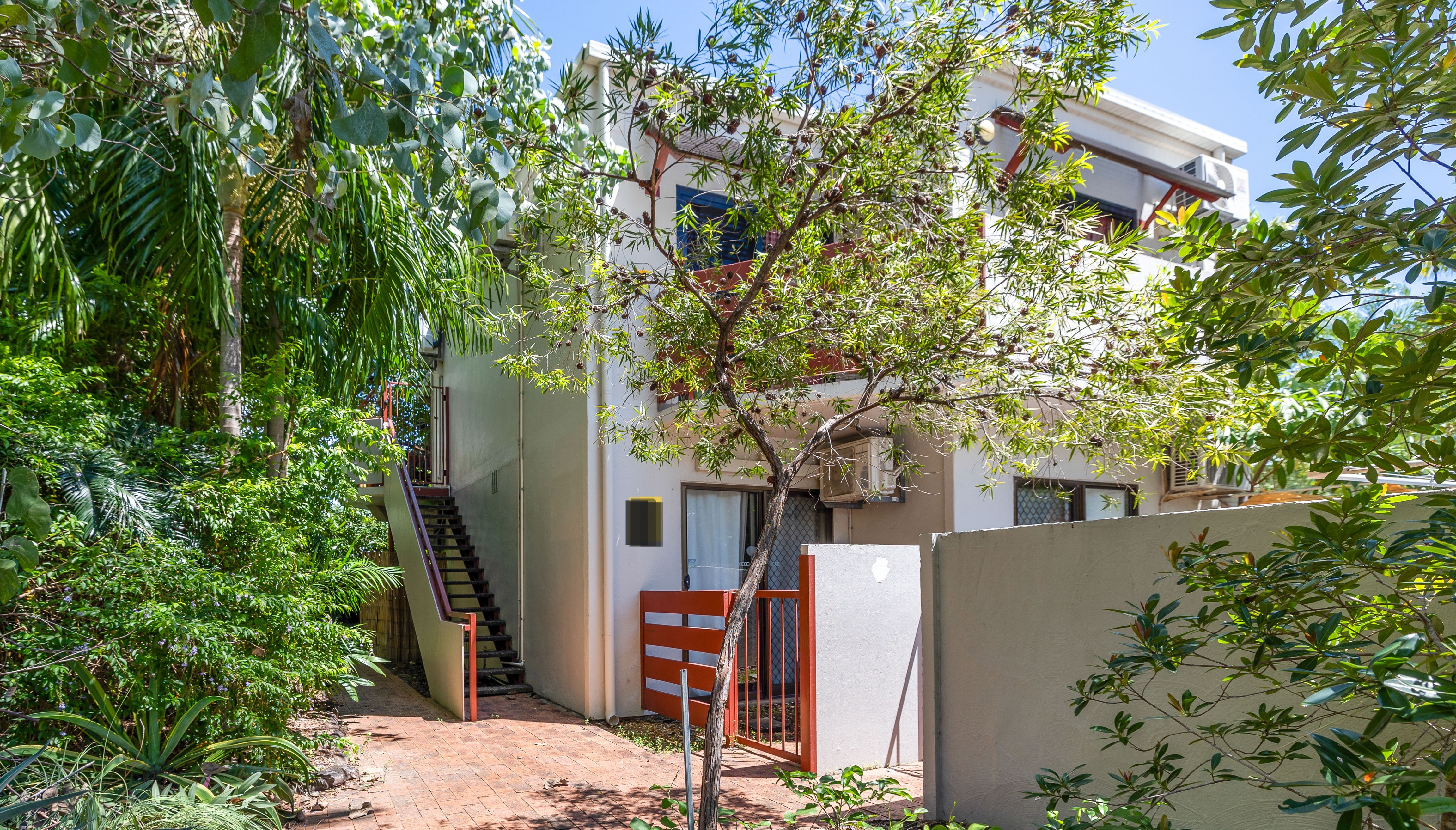 Exterior view of 76/16 Hudson Fysh Avenue Parap featuring tropical gardens, private entrance and first-floor apartment in a sought-after Darwin location