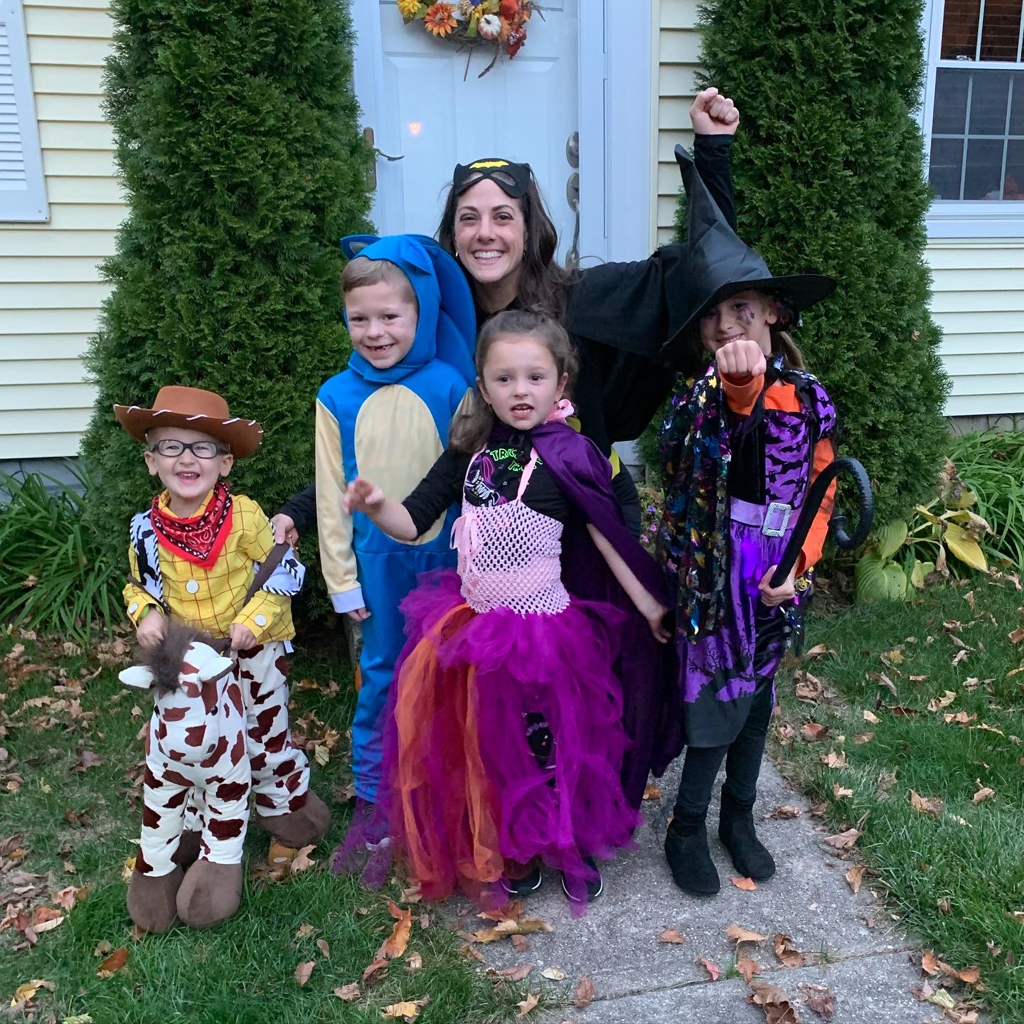 Kellie Hamilton in a Halloween costume with kids dressed up for trick or treating