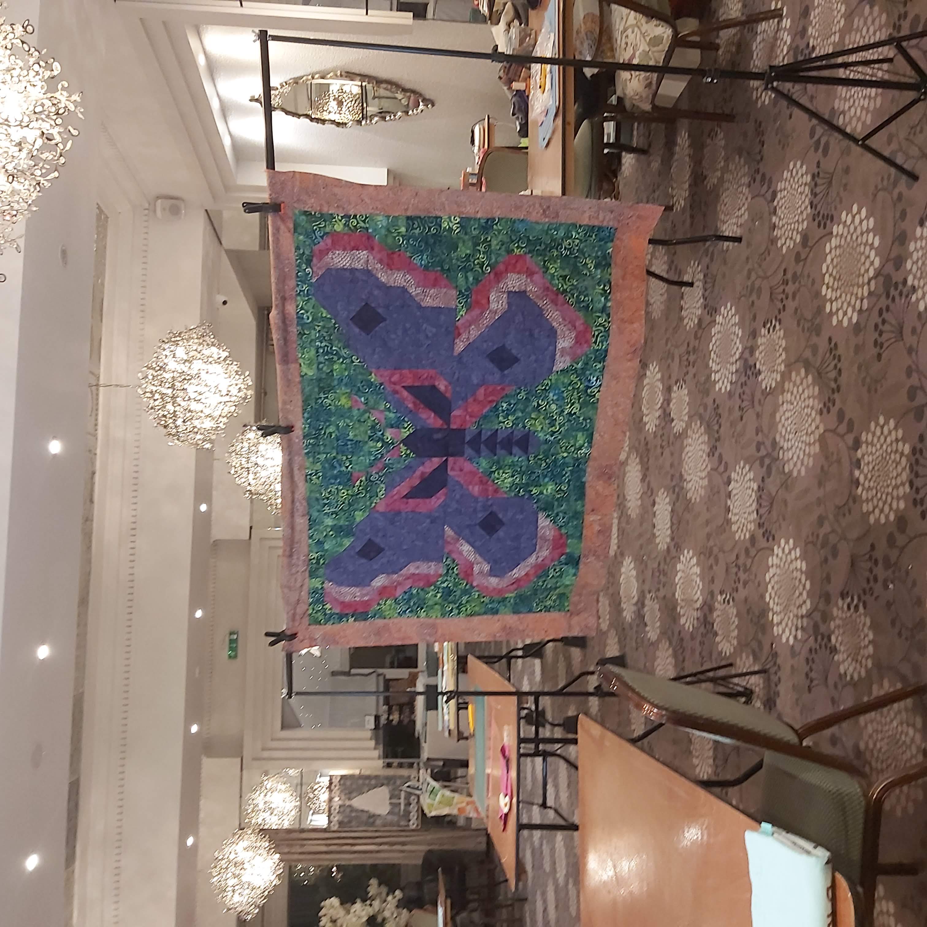 Alison's moth quilt hung on display at patchwork retreat