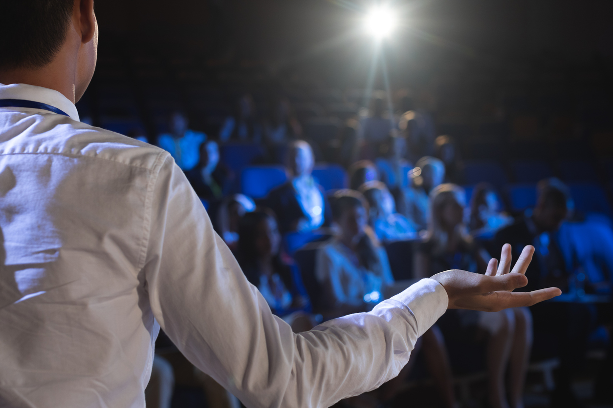 Magician giving lecture on stage