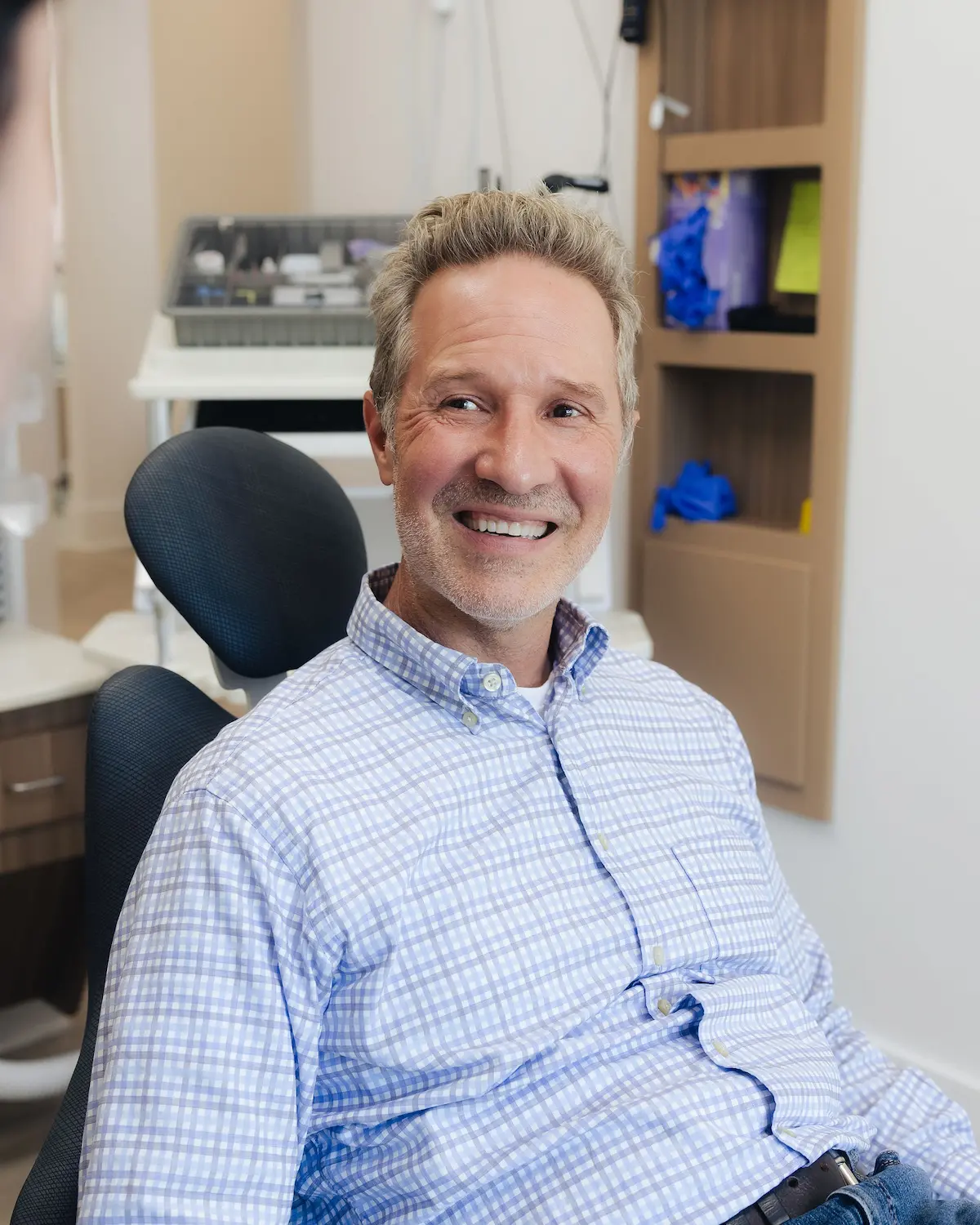 Patient smiling in the dental chair at Evelina Smiles