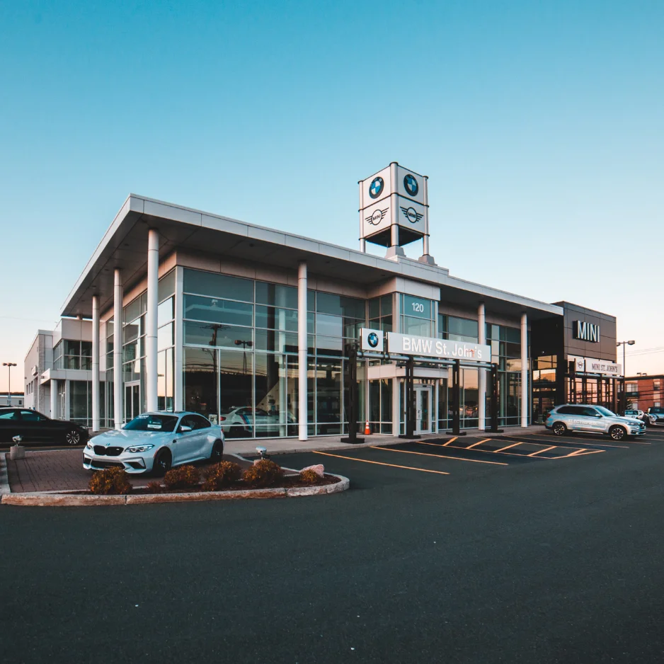 BMW dealership exterior with modern architecture, showcasing vehicles and branding, relevant to financial services and auto dealerships in AI-driven business operations.