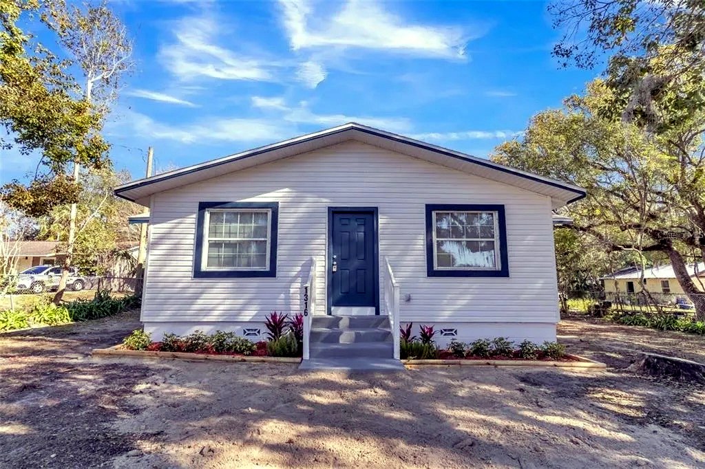After: complete siding replacement with trim, exterior paint and a landscape package