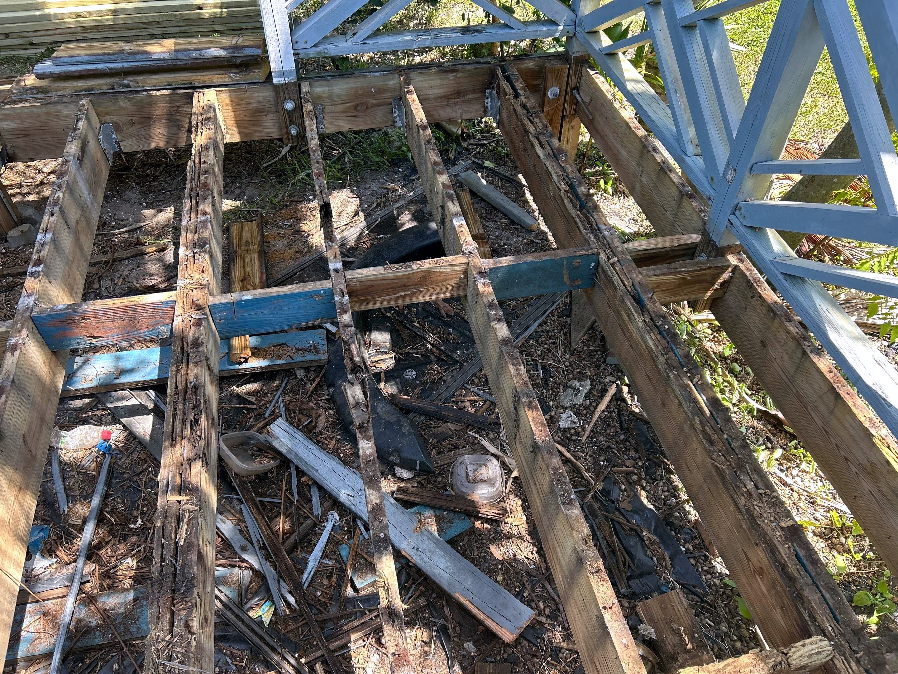 Before: rotted deck joists and beams stripped down for rebuild