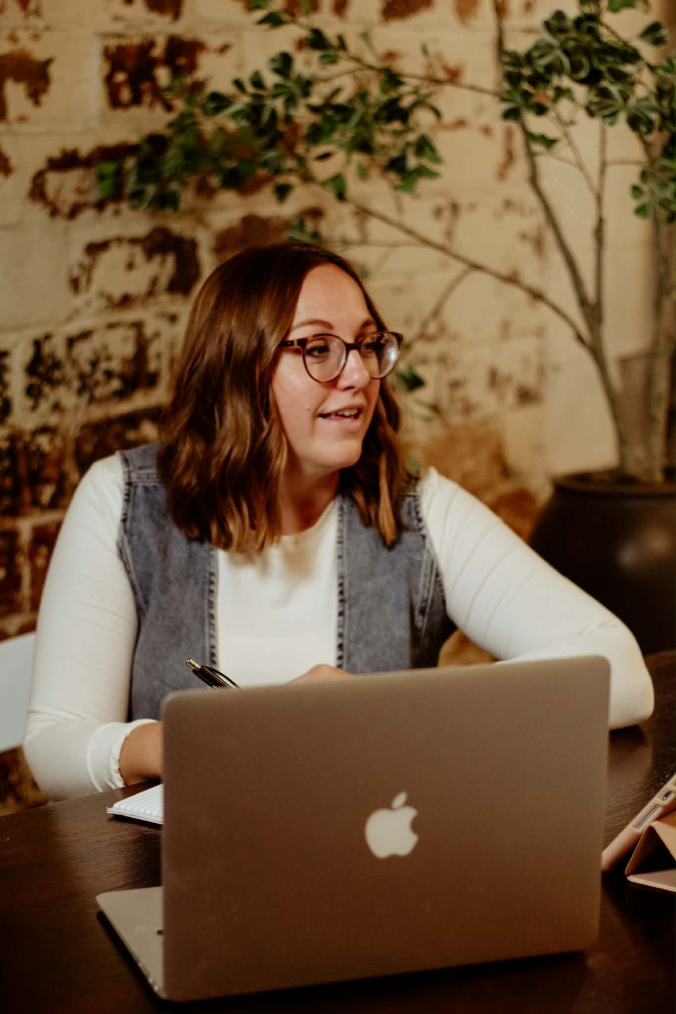 Crista talking with a client at her desk