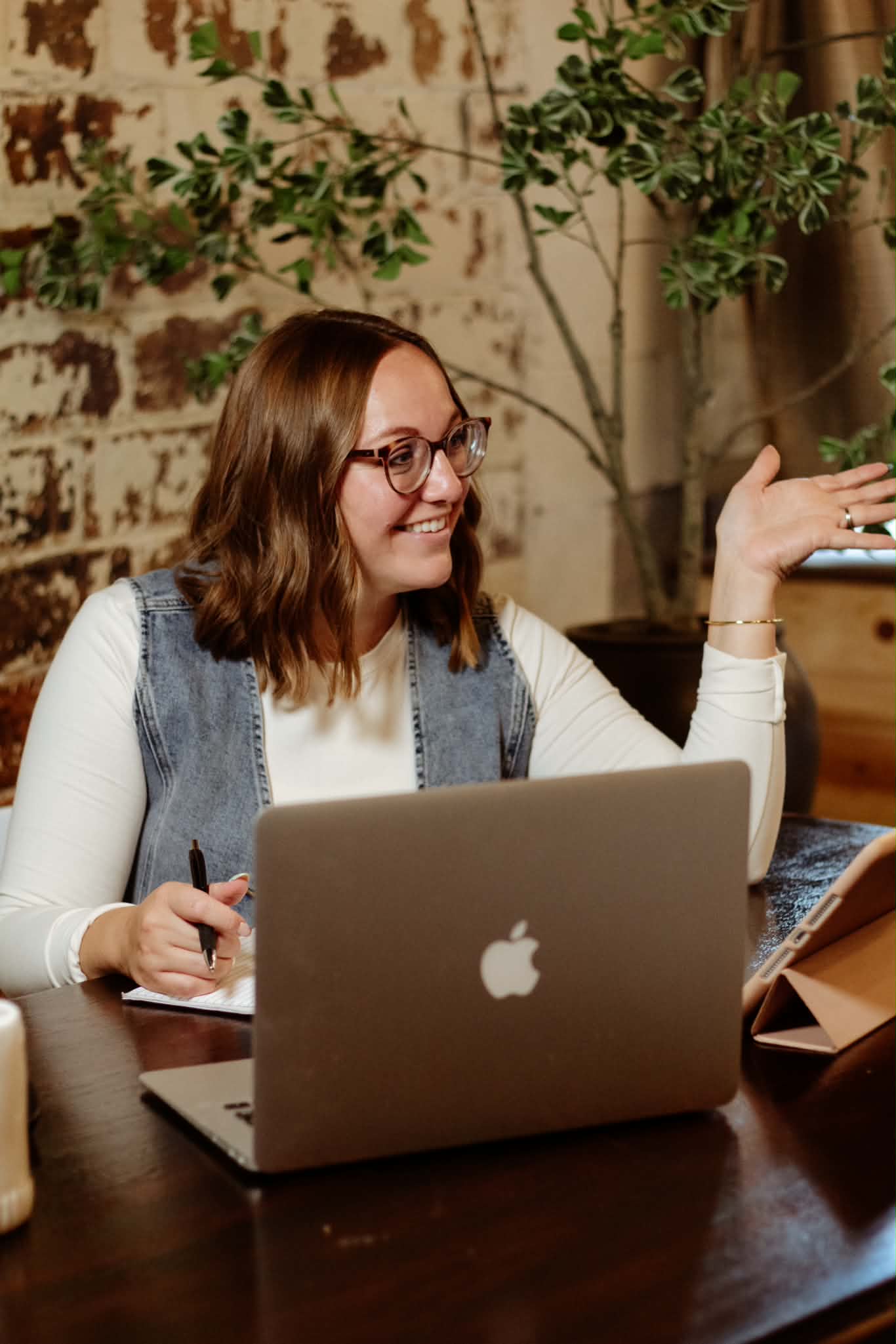 Crista talking with a client at her desk