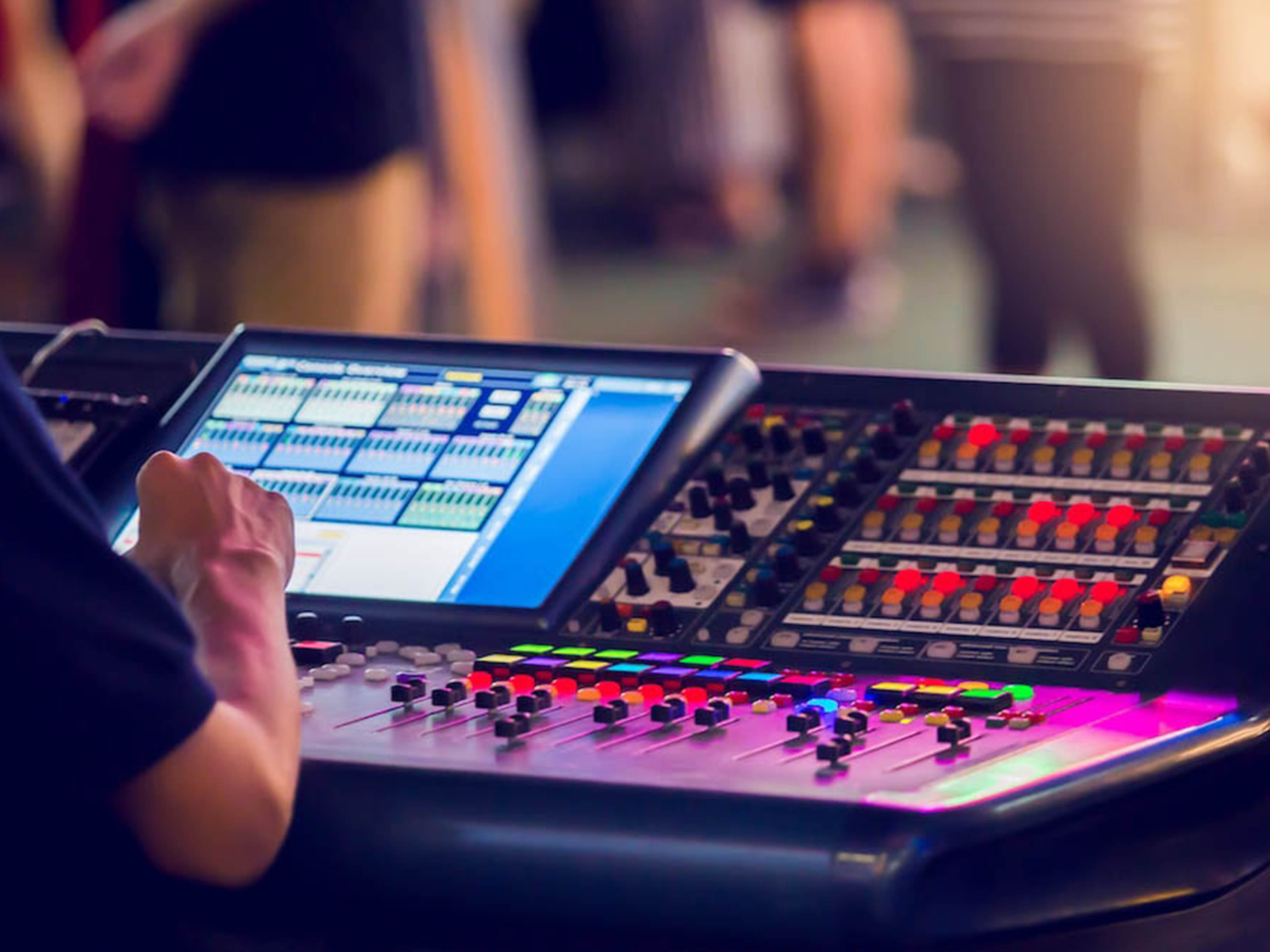 Professional sound technician operating audio equipment