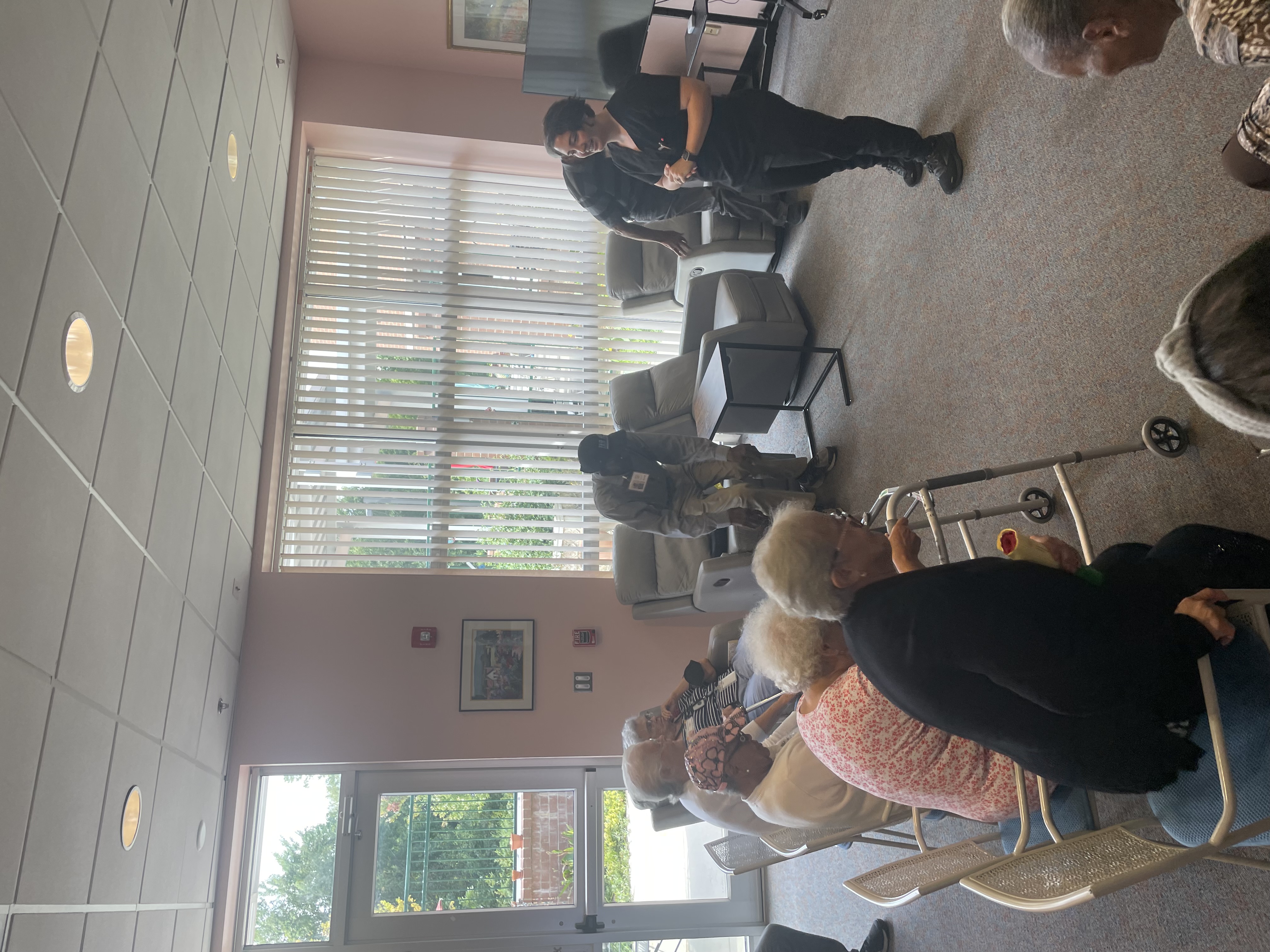 Group education workshop. People practicing seated stand-ups together.