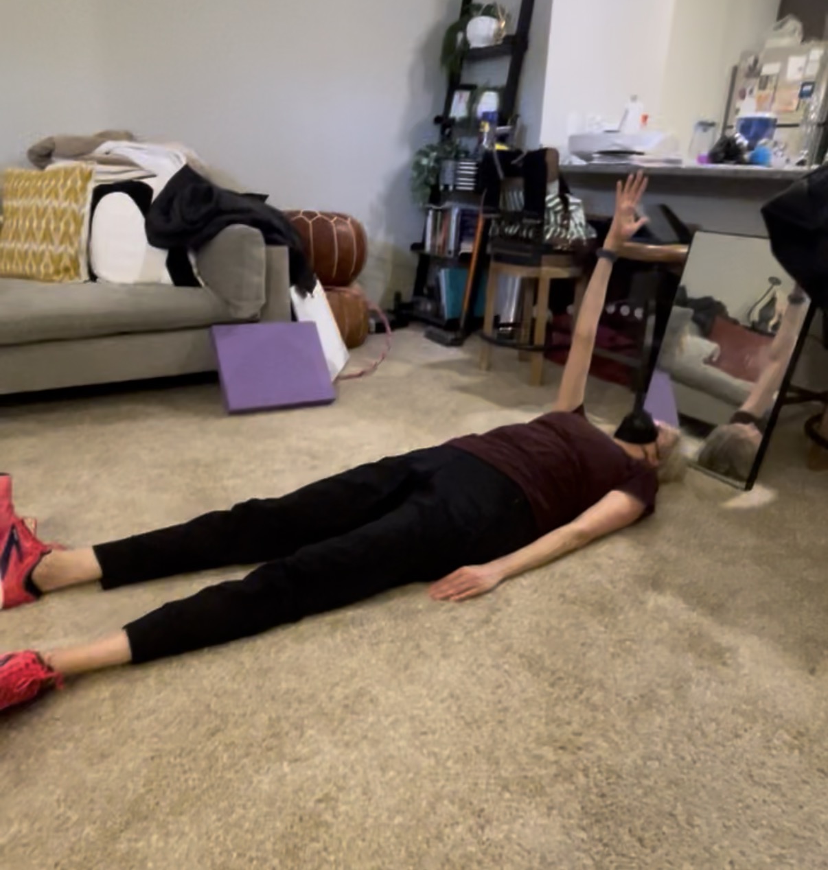 Patient doing a seated fine-motor tabletop exercise with electrical stimulation during in-home therapy.