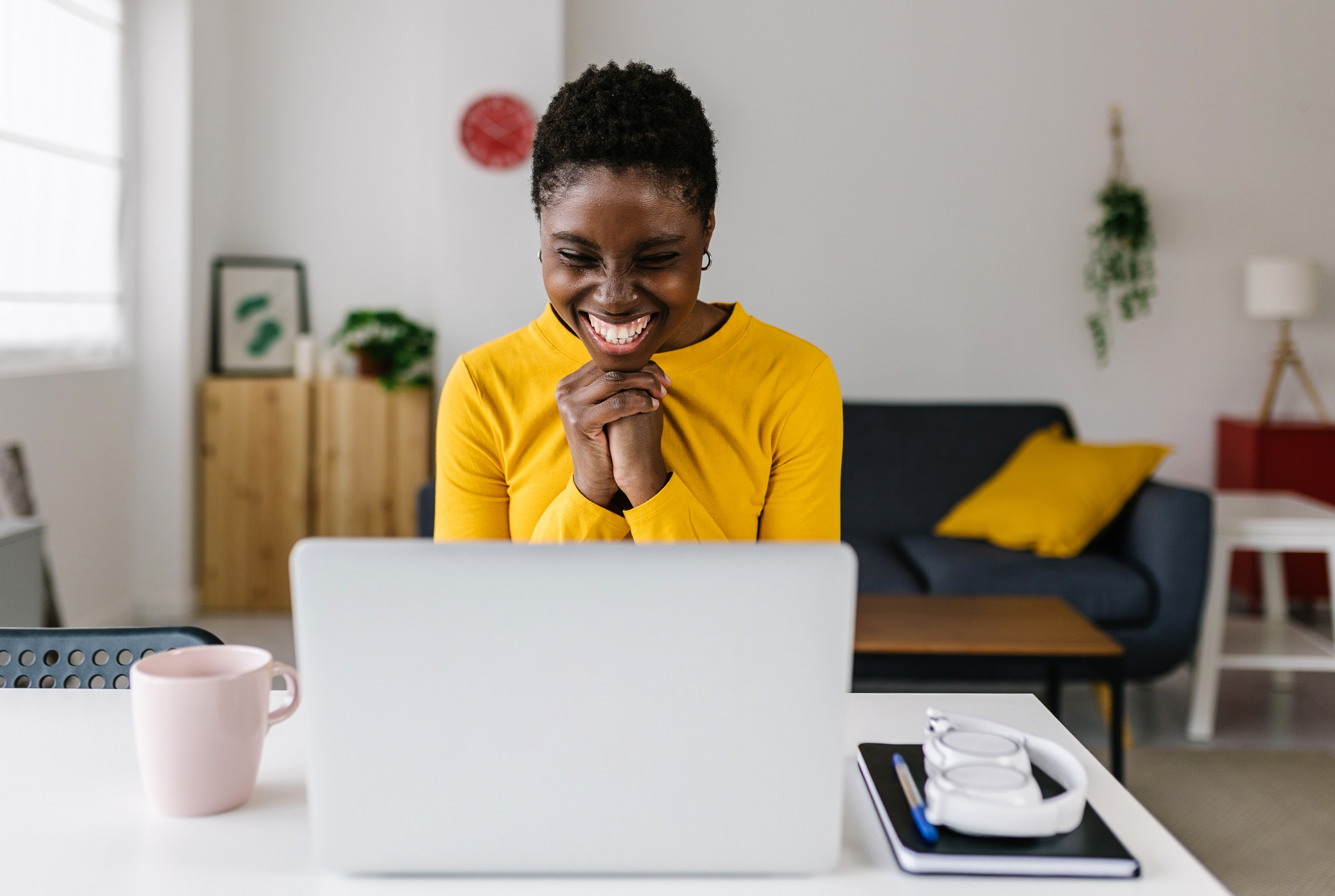 Wellness Advocate celebrating at a laptop