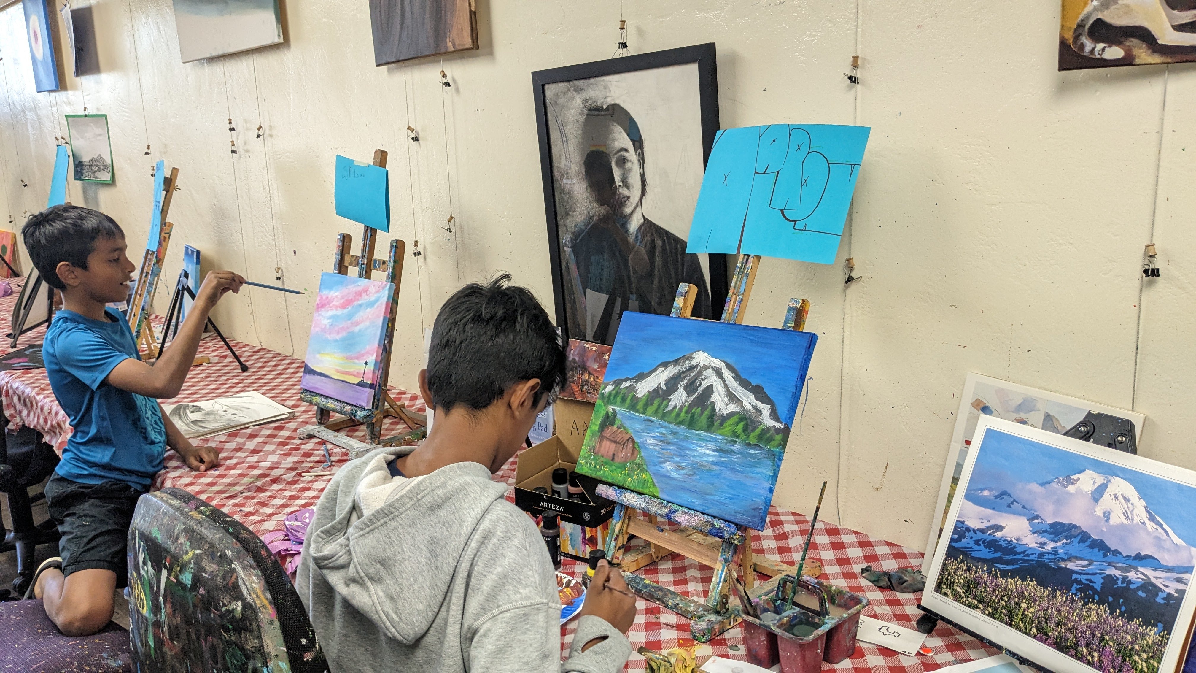 Child proudly finishing up the artwork