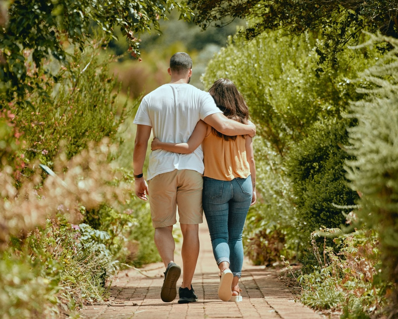Couple walking together down a path
