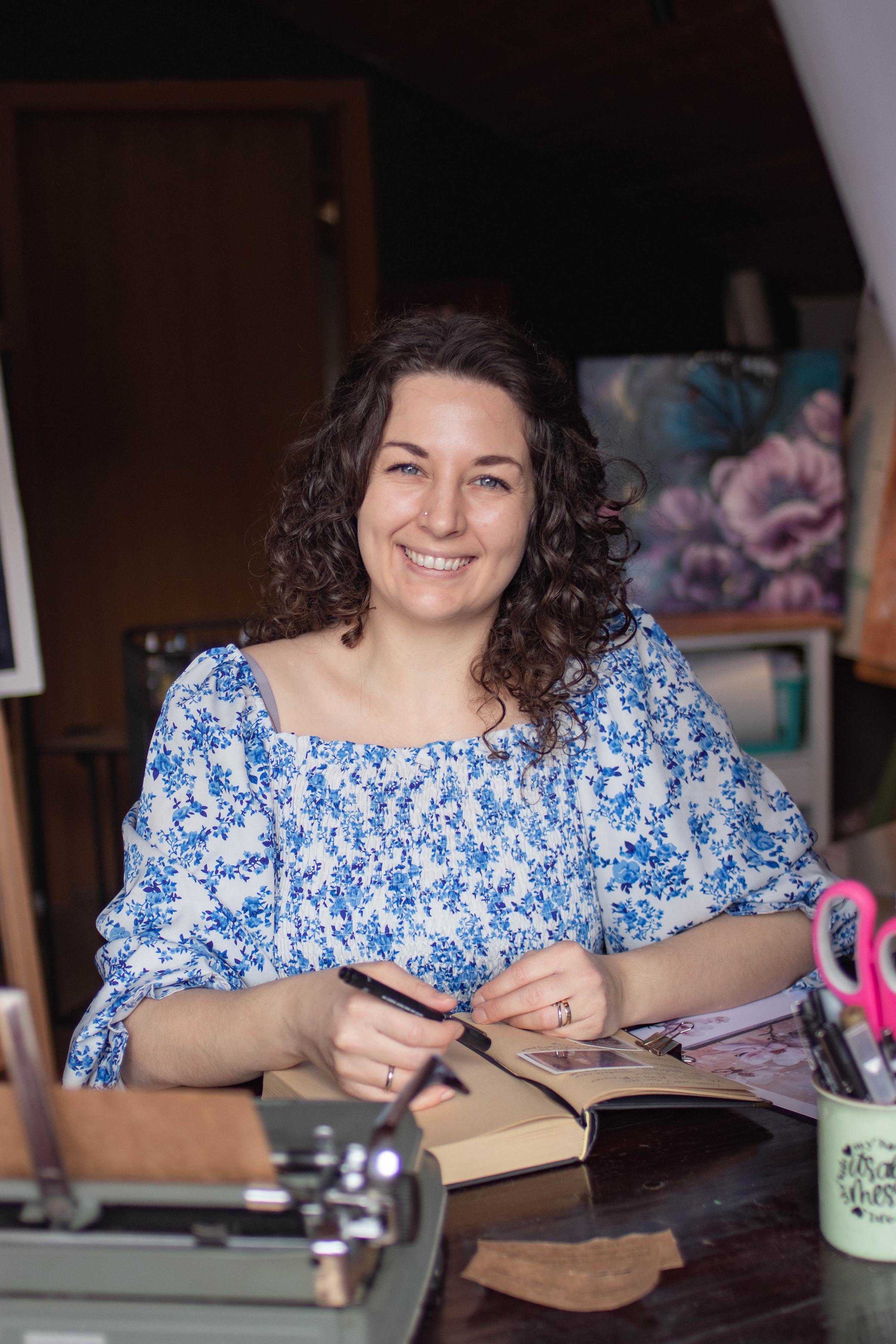 Taylor Chey in her studio with journals and coffee