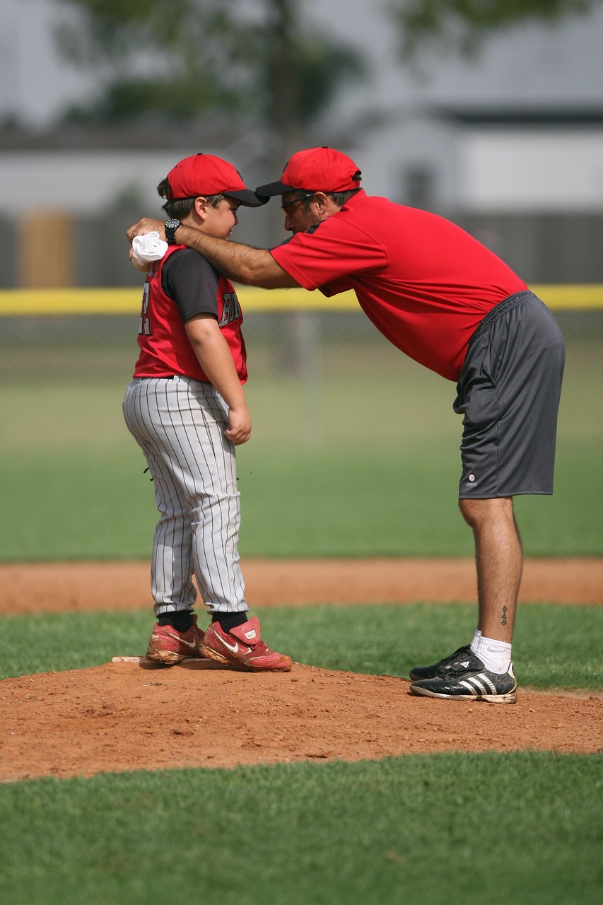 coach at pitching mond  with player