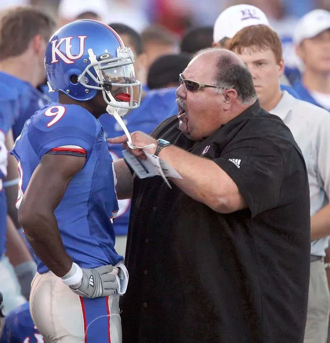 Coach fussing at football player