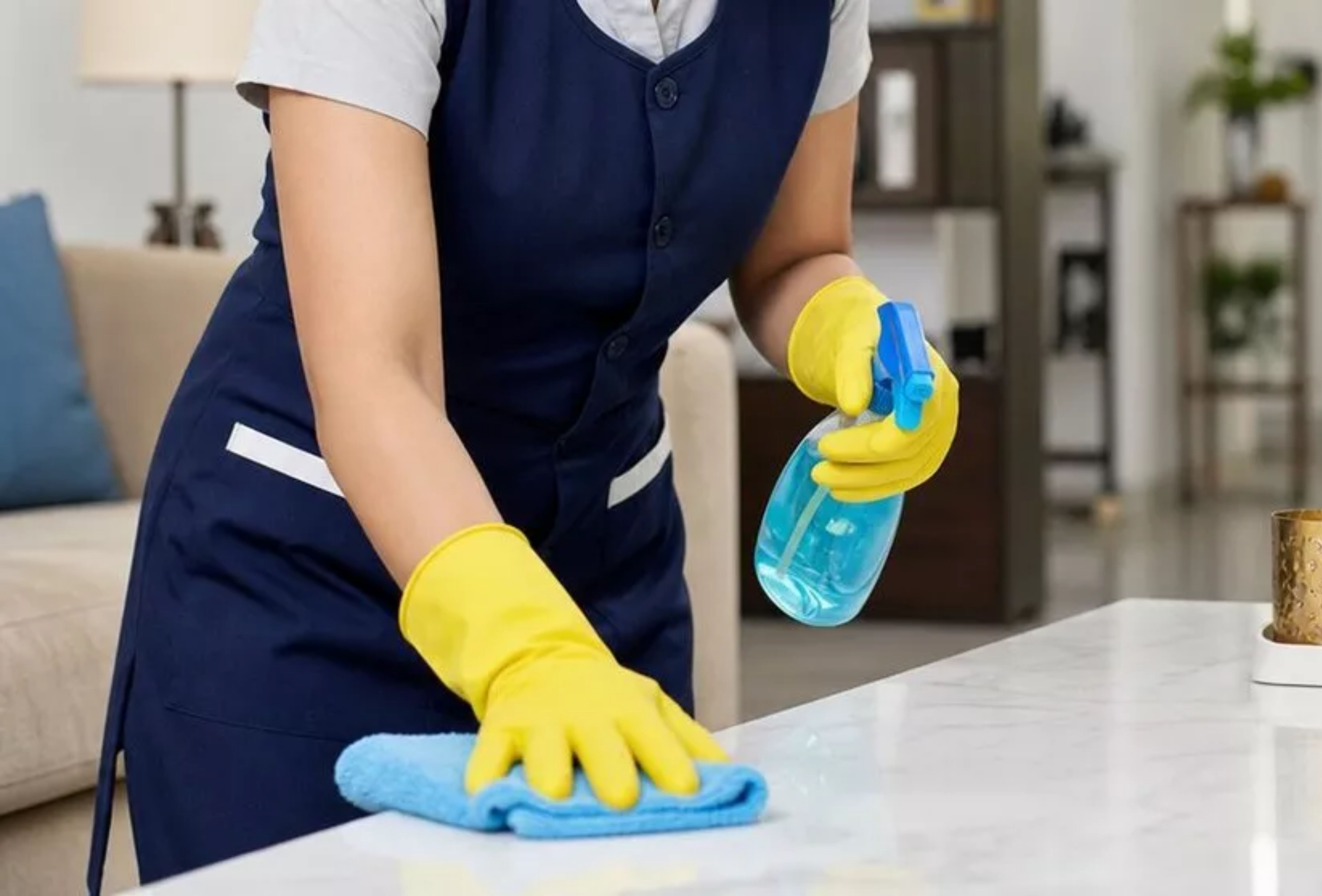 House cleaning services wiping a table during a home reset