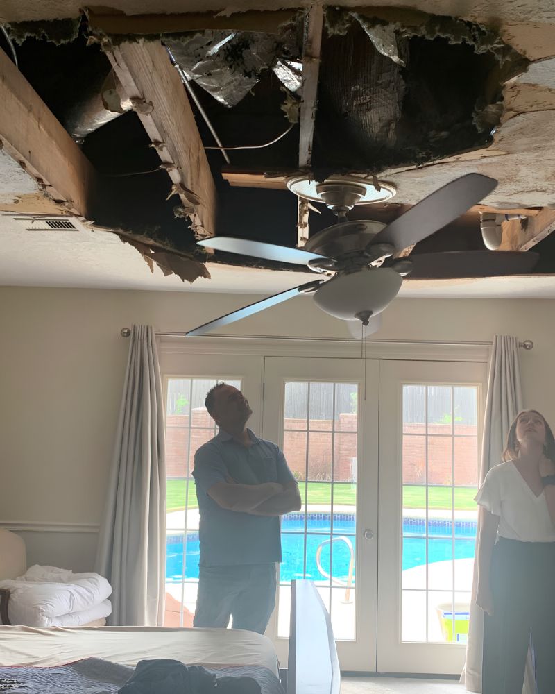 Julie Hutchison and a contractor assessing a collapsed ceiling during a property inspection in the Austin, Texas area