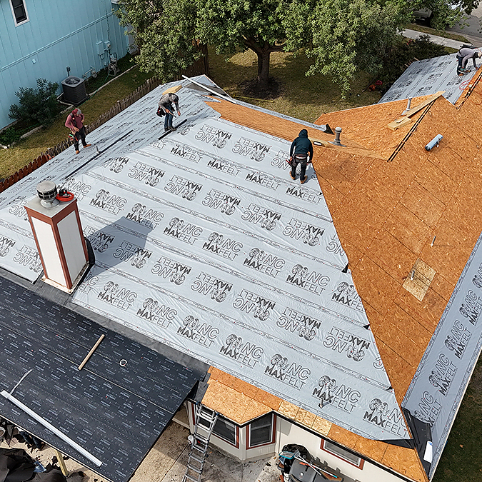 Damaged decking board being replaced during a roof replacement in Round Rock Texas