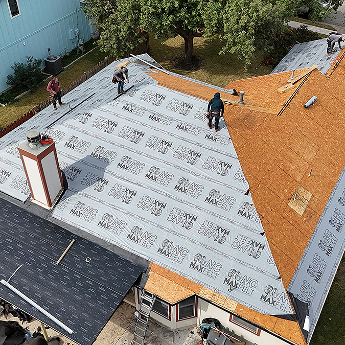 Damaged decking board being replaced during a roof replacement in Forest Creek Texas