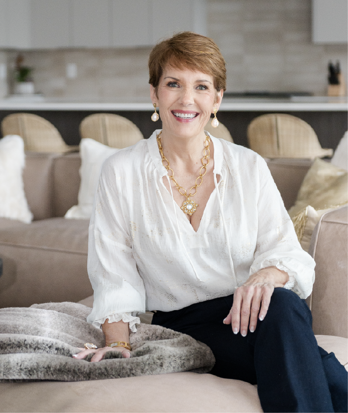 Melissa Galt, founder of Design Business Freedom, seated in a stylish interior.