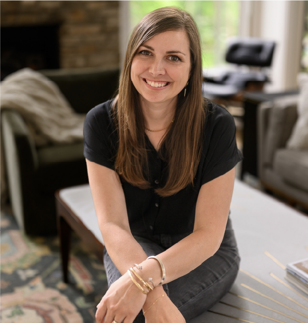 Charley Harold of Dear Charley Designs seated in a home interior.